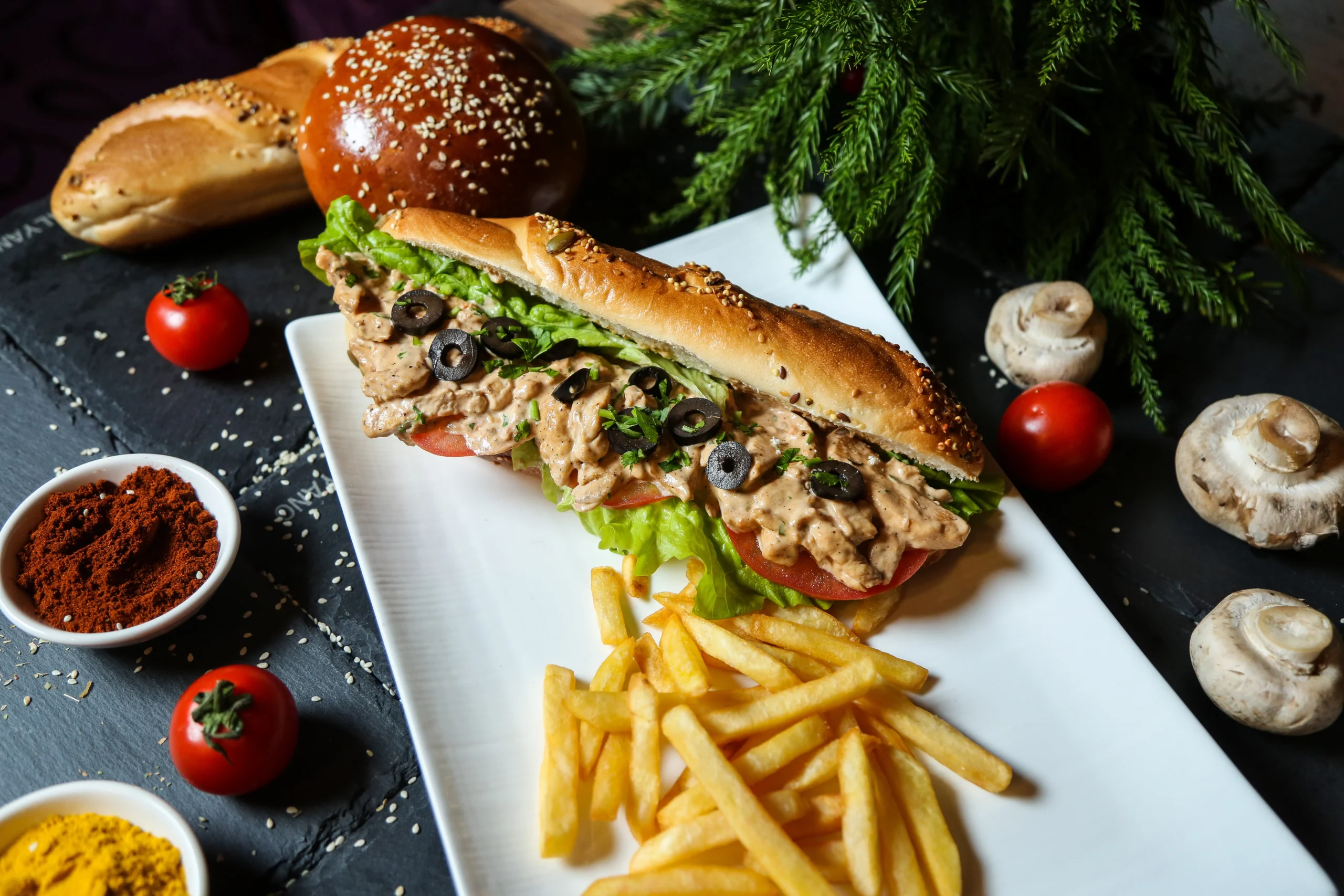 Delicious homemade chicken philly cheesesteak recipe cut in half, showcasing tender chicken, melted provolone cheese, and sautéed peppers and onions in a toasted hoagie roll.