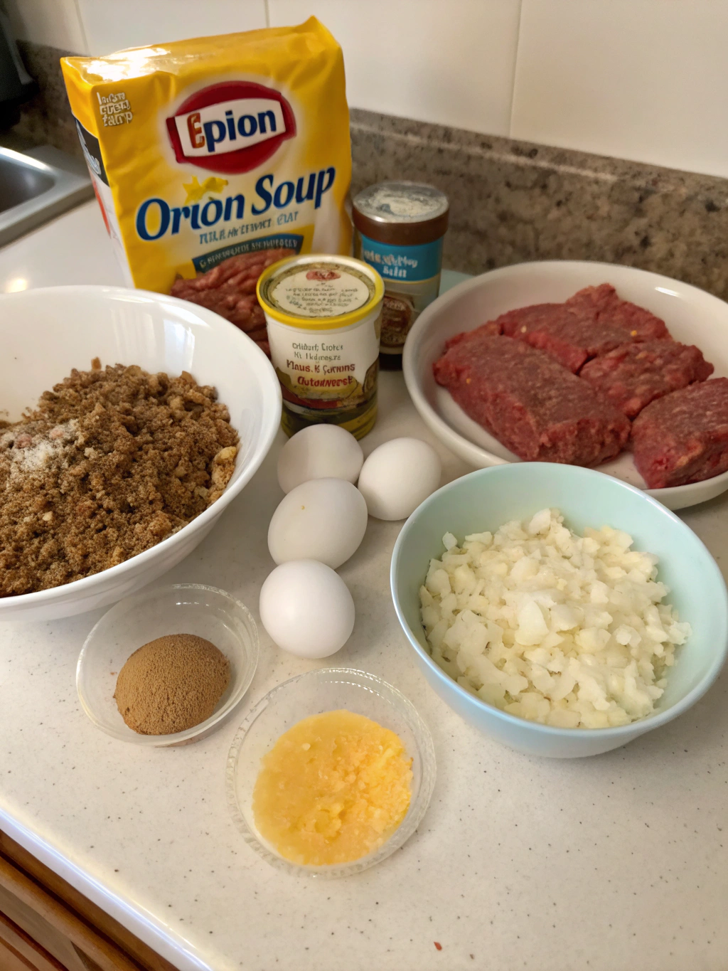 Ingredients for meatloaf recipe with Lipton onion soup including ground beef, Lipton onion soup mix, eggs, breadcrumbs, ketchup, and Worcestershire sauce.
